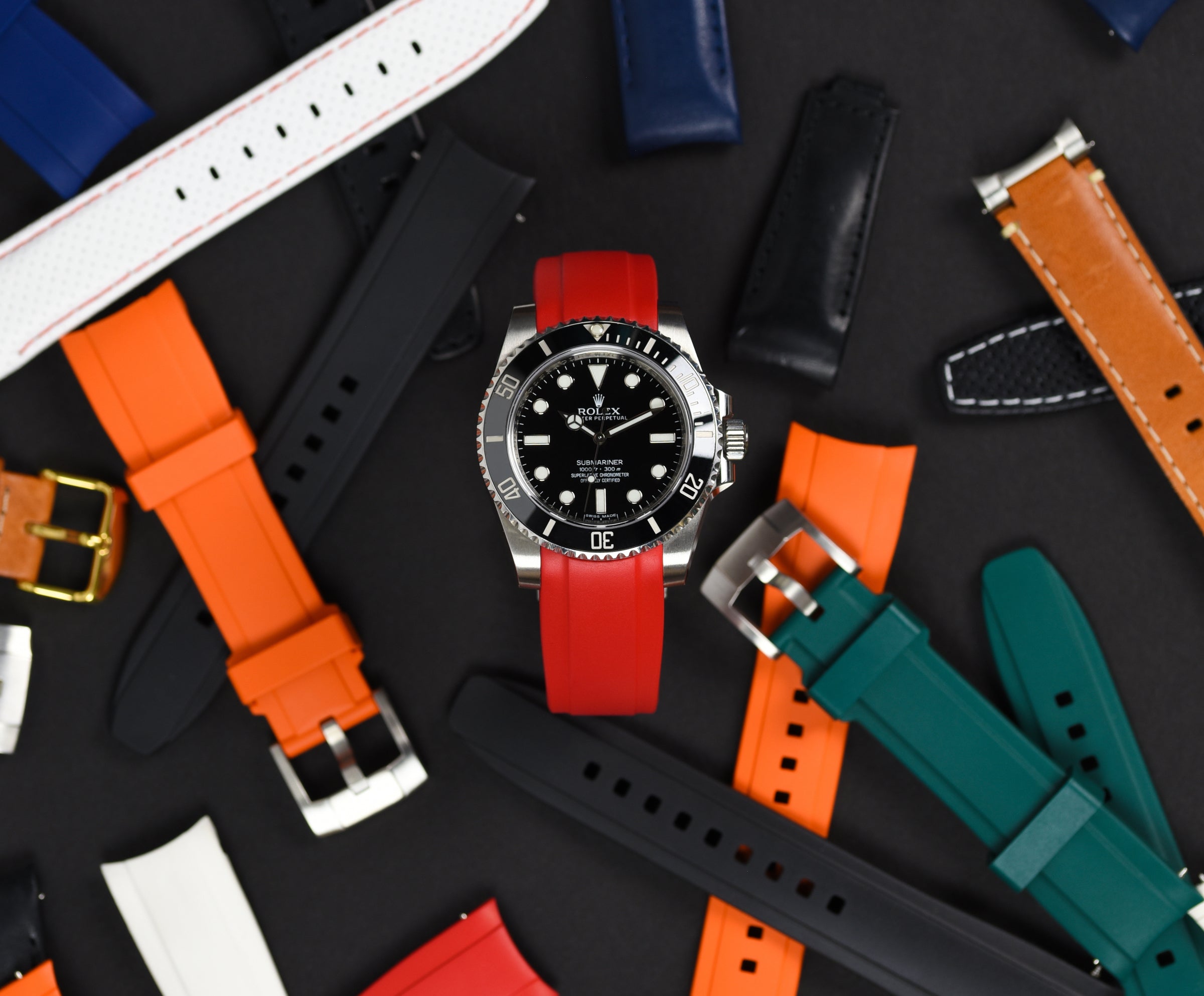 Rolex Submariner with Red Rubber Strap surrounded by various colored Everest straps